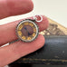Antique silver compass watch fob  in someones fingers