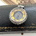 Antique silver compass watch fob  on an old jewellery box