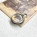 Antique silver compass watch fob  on an old photograph
