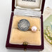 Antique 1891 threepence and pearl rop charm on an old jewellery box