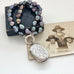 1887 sterling silver vesta case and peacock pearl necklace on an old jewellery box and with an old photo of 3 women.