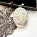 Antique Victorian era silver locket with an engraving of an urn and an old jewellery box