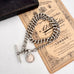 Antique watch chain and coin necklace on an old document