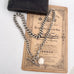 Antique watch chain and coin necklace on an old document and with an old jewellery box