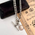 Antique watch chain and coin necklace on an old document and with an old jewellery box