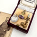 Vintage jewelry set in a display case with an old photograph of a man.