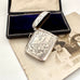 Antique 1911 William Hair Haseler silver vesta case with intricate designs on a vintage photo and box