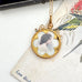 Vintage-style gold necklace with a portrait pendant on an old letter background