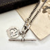 Edwardian sterling silver Albert watch chain with Isle Of Man Triskelion fob and edwardian T bar on an old photo with an old jewellery box. Chester hallmarks 1903