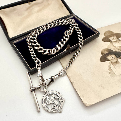 Edwardian sterling silver Albert watch chain with Isle Of Man Triskelion fob and edwardian T bar on an old photo with an old jewellery box