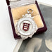 1929 Fattorini silver watch fob featuring the 3 Lions emblem for Lancashire on a beige cushion in a wooden box