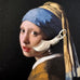 Vintage silver dutch clog charm on a picture of the painting of The Girl With A Pearl Earring.
