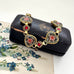 Vintage micro mosaic bracelet with floral designs in a jewelry box on a floral vintage postcard.