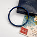 Vintage blue cloisonne bangle on an old jewellery box and vintage postcard