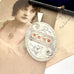 Antique 1885 sterling silver and rose gold locket with an old postcard of a woman.