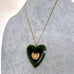 Large New Zealand greenstone and 9ct gold heart pendant on a grey mannequin