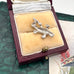 Silver platypus charm/pendant in a jewelry box on a textured surface