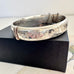 Vonk Jewellery vintage sterling silver half engraved bangle on a black box