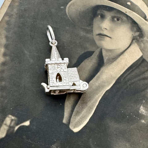 Vintage sterling silver opening church charm on an old photograph of a young woman