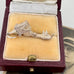 Vintage sterling silver opening church charm on an old photograph of a young woman and in a box