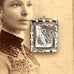 Vonk Jewellery Victorian silver aesthetic locket with swallow on one side and monogram on the other on an antique photo of a woman.
