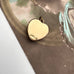 Vintage gold heart shaped heart locket on a vintage photograph background