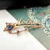 Vintage Mother brooch on an old postcard