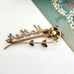 Back of a vintage Mother brooch on a white background