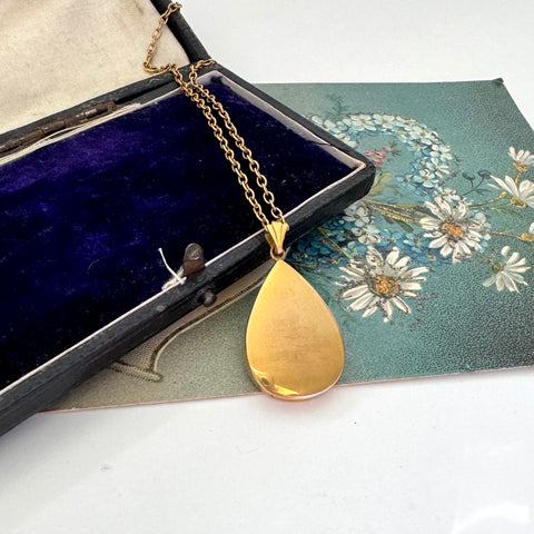 Vintage Handley Australian mid century gold fill teardrop pendant necklace on a floral card with a jewelry box in the background