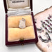 Vintage silver Eastbourne travel charm on a jewellery box