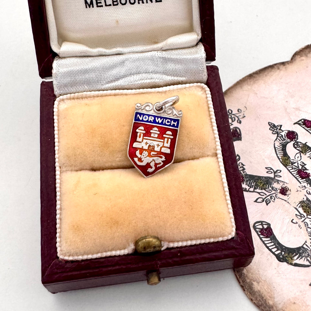 Vintage Norwich silver travel charm on a jewellery box