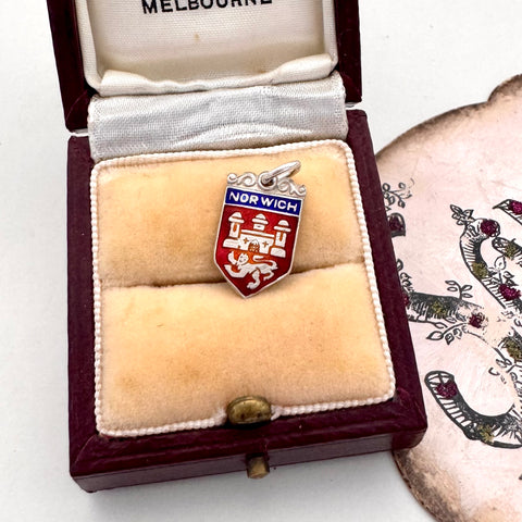 Vintage Norwich silver travel charm on a jewellery box