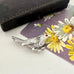 Vintage Sarah Coventry silver bird-shaped brooch with a red gemstone with an old jewellery box and postcard