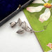 Vintage Danish John Lauritzen silver leaf and rose brooch on a vintage postcard