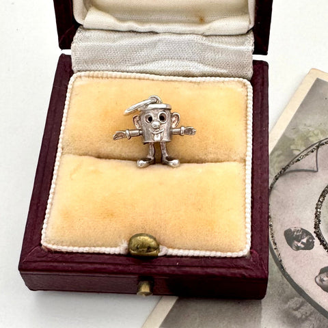 Silver vintage Dusty Bin charm in a Melbourne jewelry box on a white background