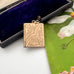 Vintage book locket with floral engraving on a floral-patterned fabric background