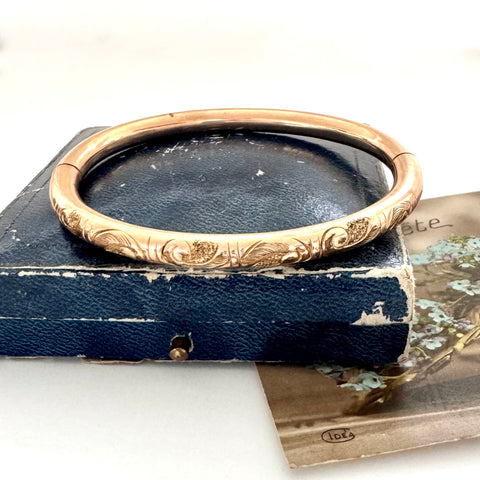 Antique gold fill bracelet on an old box with a white background