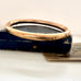 Antique gold fill bracelet on an old box with a white background