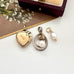 Three vintage pendants on a white surface with a floral background