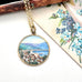 Vintage hand painted pendant featuring a scene of Rapallo on the Italian riviera. It is with a vintage postcard and old jewellery box