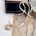 vintage heart locket and pearl and peruvian opal necklace on an open jewellery box and with a vintage postcard.