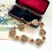 Vintage micro mosaic bracelet with floral designs in a jewelry box on a floral vintage postcard.