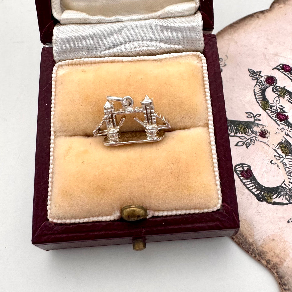 Vintage silver London Bridge charm on a jewellery box