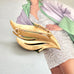 Back of Mid century Crown trifari gold tone leaf brooch photographed on an image of Linda Evangelista in a Vogue magazine cover