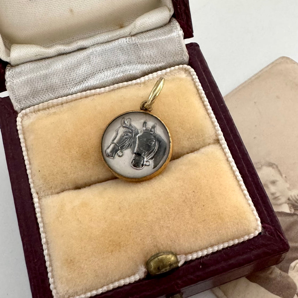 Vintage reverse carved lucite horse charm on an old jewellery box