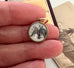 Vintage reverse carved lucite horse charm in a woman's fingers