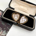 Open vintage heart locket in an old jewellery box