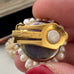 Close up of a Grosse pearl clip on earrings showing the brand signature