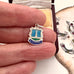 Vintage silver charm with 'Blackpool' text held between fingers
