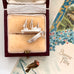 Vintage silver  Mayflower ship charm in a jewelry box with a vintage card in the background